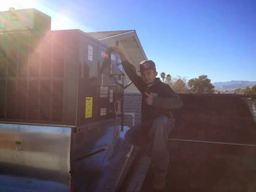 HVAC technician performing HVAC Inspection on a rooftop unit in Gainesville
